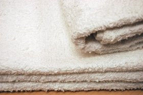 What fabric is used for bulk rally towels?