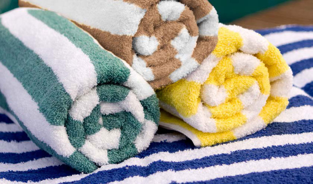 What fabric is used in the luxury pool towels of the Cabana Stripe Pool Towels-Premium?
