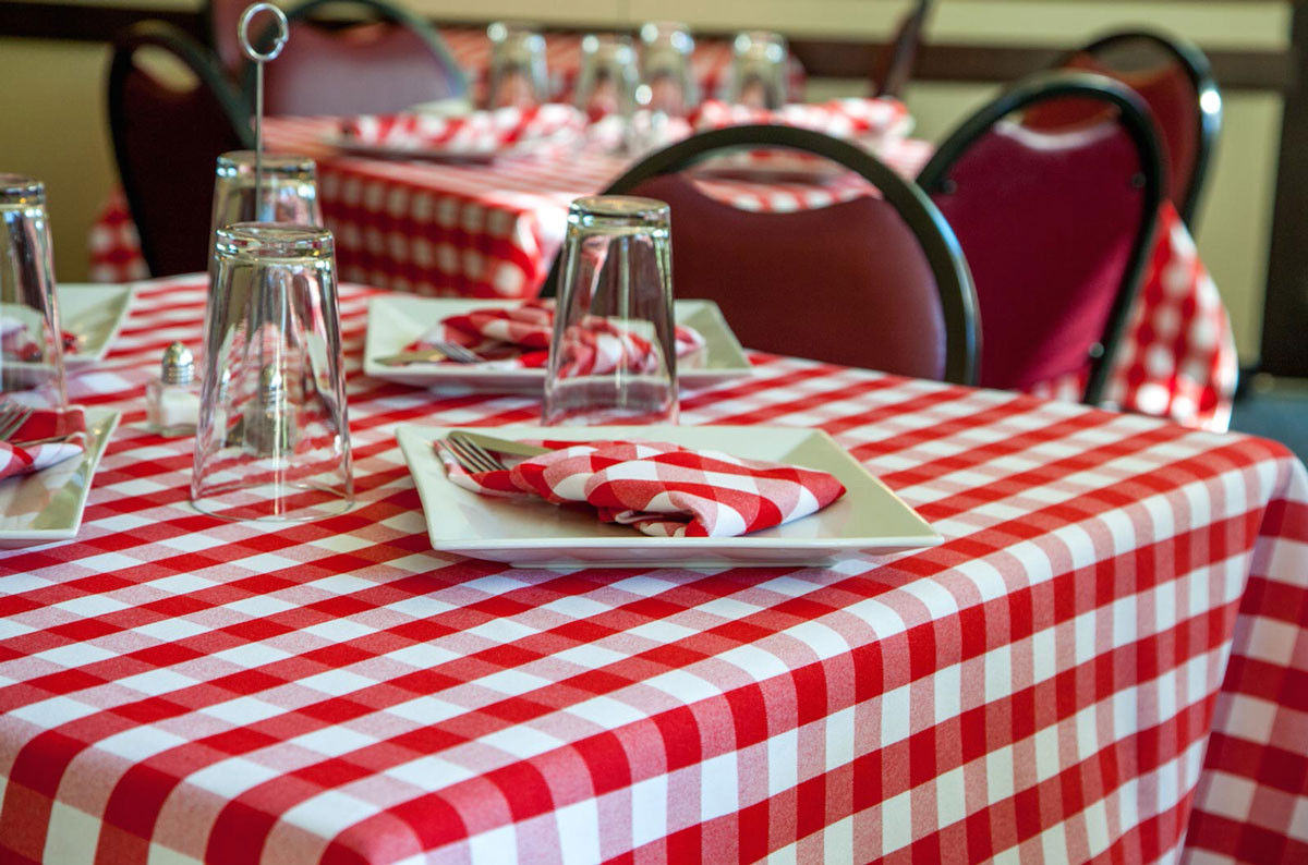 What design style is showcased by the Milliken Visa Plain Checkpoint Table Linens?