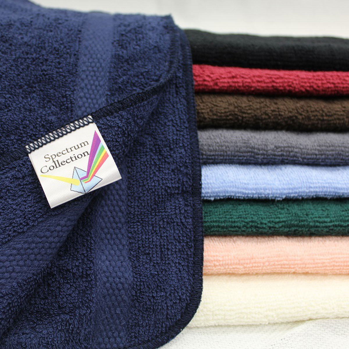 What type of yarn is used in the Spectrum hotel quality towels collection?